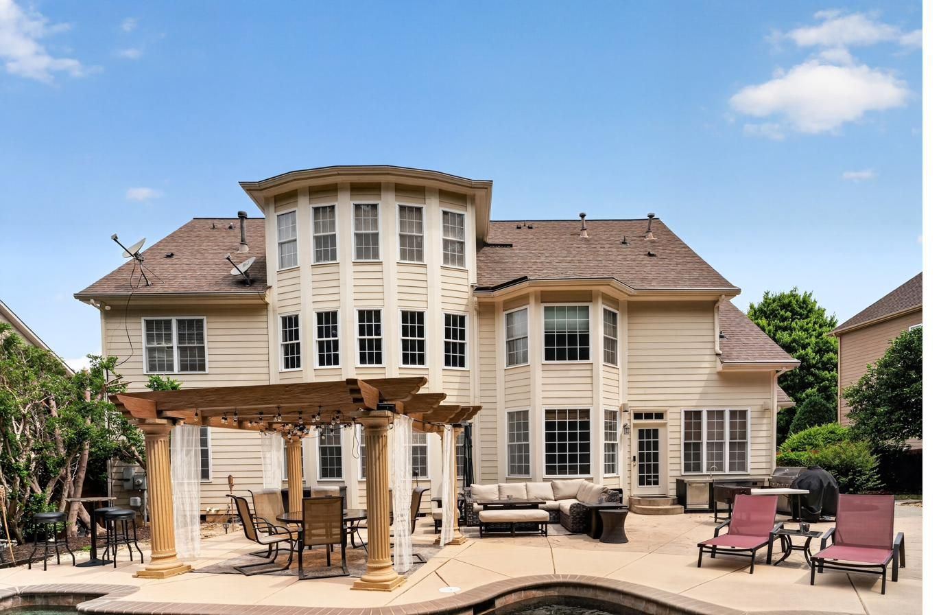 Covered pergola and outdoor living overlooking the pool